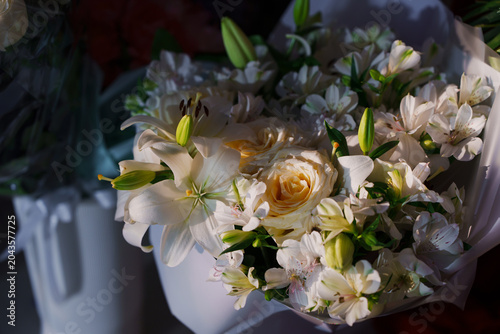 Elegant bouquet of white lilies and roses