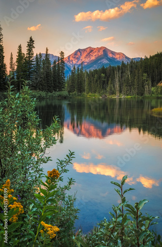Mount Rundle reflecting in a lake at sunset