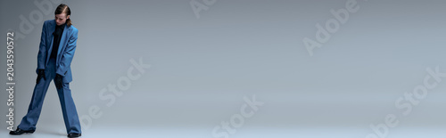 Photography Young man showcases modern fashion in stylish blue outfit during studio session