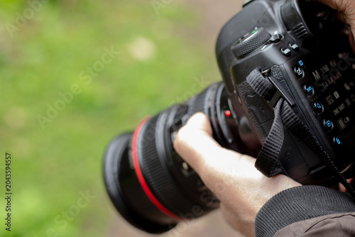 photographer taking photo with camera in nature, closeup