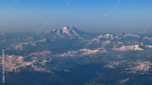 Aerial view of Mount Elbrus and snowy Caucasus mountain range at sunrise