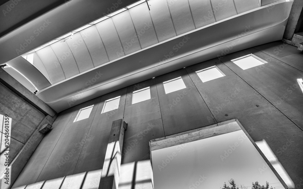 Fototapeta premium Large unfinished industrial space featuring metal beam framework and raw warehouse construction interior details