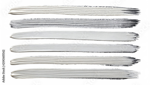 Six white paint brush strokes with varying textures and thickness on a isolated on a transparent background