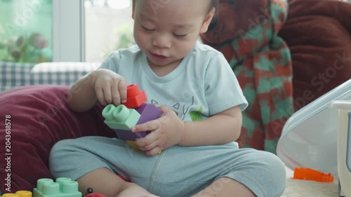 A young child is engaged in creative play with colorful building blocks, fostering imagination and development.