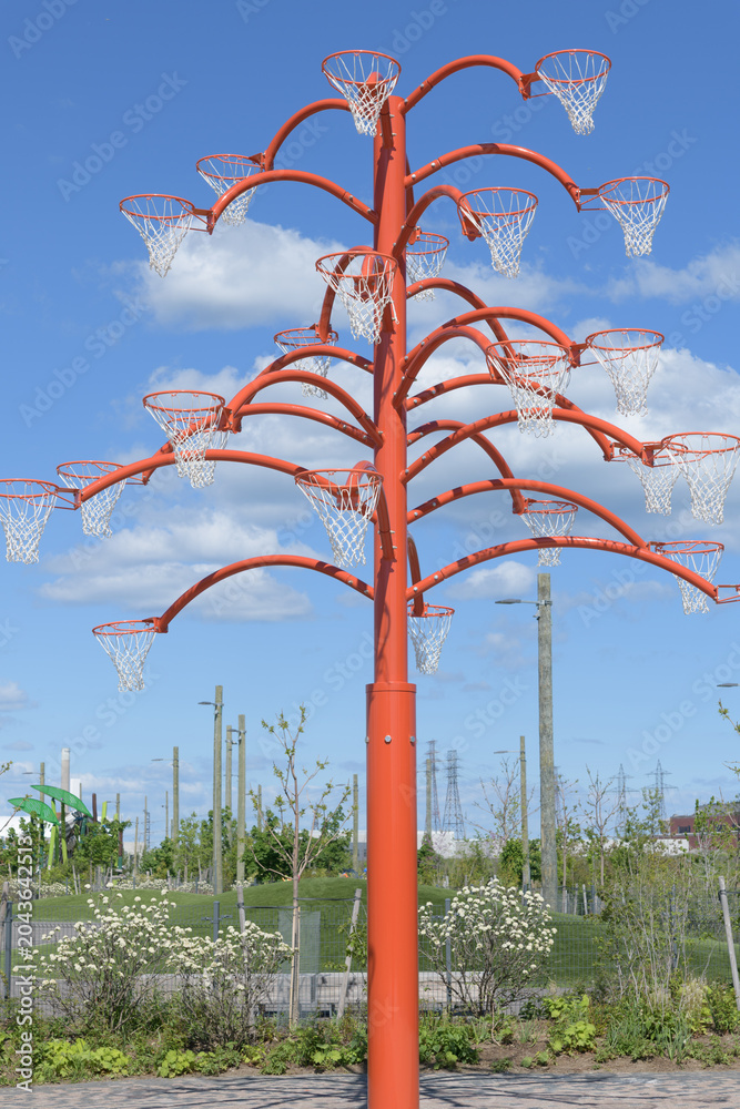 Naklejka premium Orange Functional tree, a striking 20-foot-tall pubic art sculpture, by Cuban artist Alexandre Arrechea, Toronto's Port Lands, right in front of the historic Old Fire Hall 30 (39 Commissioners Street)