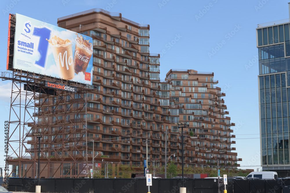 Naklejka premium McDonald's Canada spectacular billboard on an intricate steel truss work frame near Small St and Queens Quay E, with a stunning view of Aqualuna Condos, Toronto