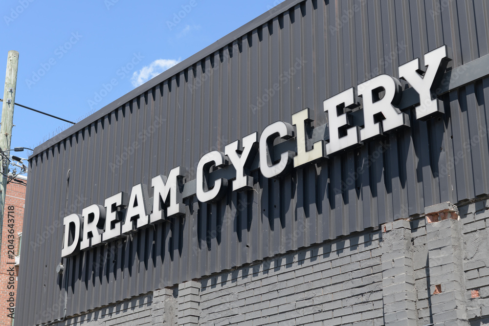 Naklejka premium old sign outside Dream Cyclery, a bicycle shop, located at 941 Kingston Rd near Silver Birch Av, The Beaches, Toronto