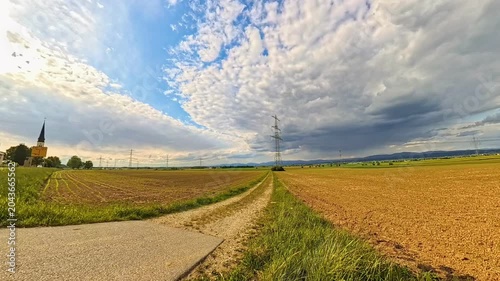 4K Timelapse video with moving clouds and a church near Wallerdorf, Kuenzing, Deggendorf, Bavaria, Germany