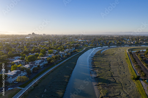 Εκτύπωση καμβά Redwood Shores waterfront homes along a tidal slough at sunset, showing suburban