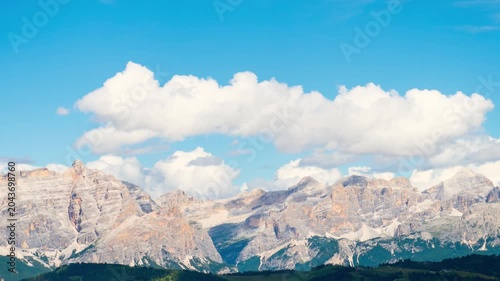 Timelapse Dolomites mountain range Italy jagged peaks moving clouds blue sky alpine landscape summer nature rocky limestone ridge scenic vista horizontal panorama outdoor environment banner background