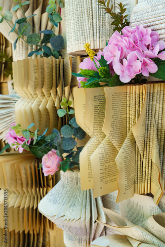 Decorative arrangement of book pages and flowers in a creative display