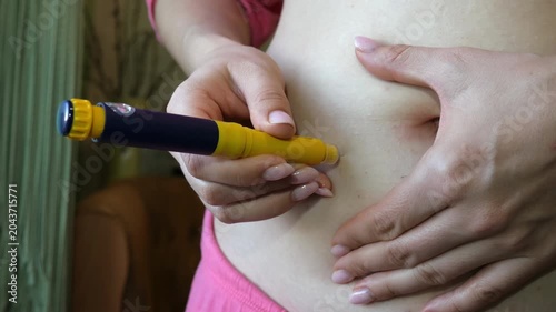 Young Woman Self-Injecting Medication into Abdomen at Home Close Up Healthcare Treatment