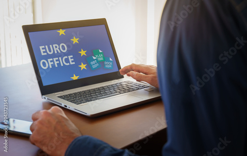 Businessperson working on a laptop with EURO OFFICE on the screen, representing the concept of digital sovereignty and open source software solutions for the European Union.Concept of European digital