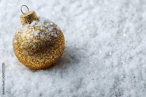 Sparkling gold Christmas ornament adds festive cheer to winter holiday designs, evoking warmth and joy during the holiday season
