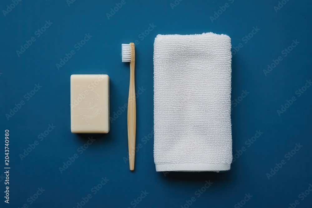 Obraz premium A still life of a bar of soap, toothbrush, and towel on a blue surface