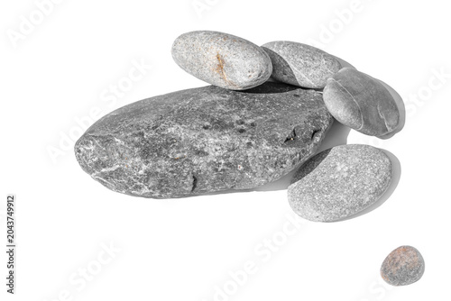 Horizontal wide shot of a cluster of smooth river stones isolated on white or transparent background. Organic mineral shapes with detailed grain for minimalist spa and wellness design projects