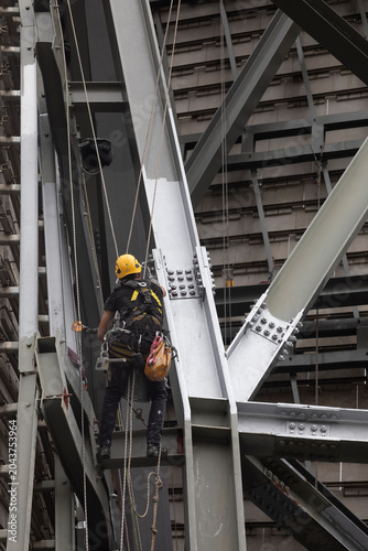 Painters performing rope access work. Workplace safety. Personal protective equipment. Hazardous profession