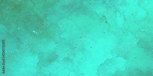 Photos Teal watercolor background with green undertones and splatters for creative desi