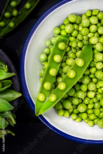 Title:
Fresh green peas in a bowl with open pea pods