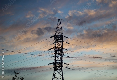 Power line and wires against the backdrop of a sunset sky beautiful summer photo urban landscape infrastructure city