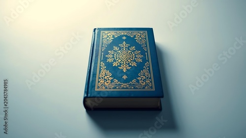 Closed Blue Holy Quran Book on White Background with Islamic Calligraphy Pattern