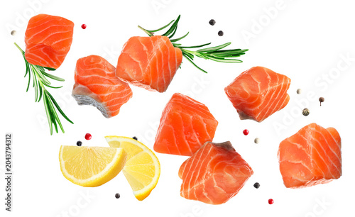 Salmon pieces  lemon  rosemary and peppercorns flying in air on transparent background