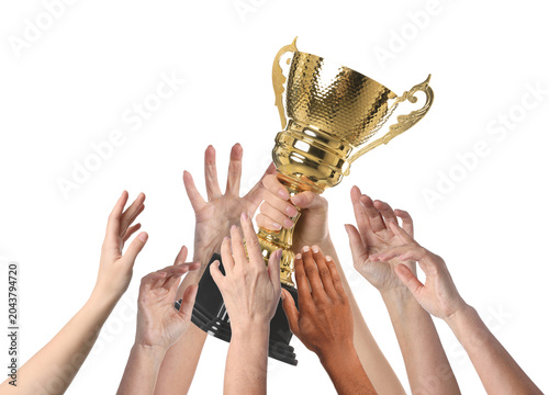 People reaching for gold cup held by winner against white background, closeup