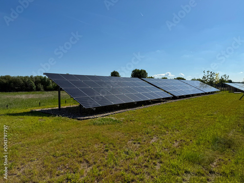 Modern Solar Power Plant on a Green Field, Renewable Clean Energy Production