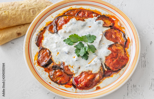 Burani Bonjan Afghan eggplant dish with yogurt garlic sauce and parsley garnish