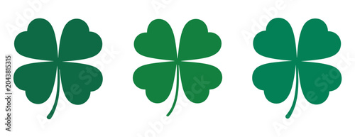 Tableau sur toile Four-leaf clover: A trio of vibrant green four-leaf clovers, each with four heart-shaped leaves, arranged in a row, symbolizing good luck and fortune