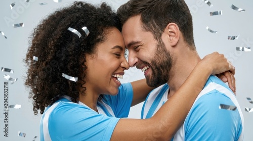 Happy couple embracing and smiling outdoors in bright daylight with confetti celebration