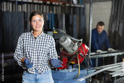 Photos Portrait of positive female worker in workshop of a metallurgical plant