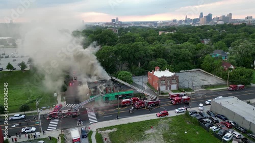 burning building in front of city skyline