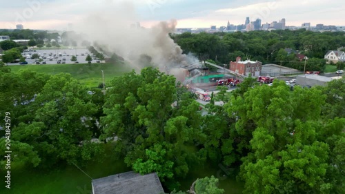 Aerial view of building fire being put out by firefighters