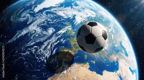 Soccer ball floating in space above planet Earth. Global football tournament concept. International sports background