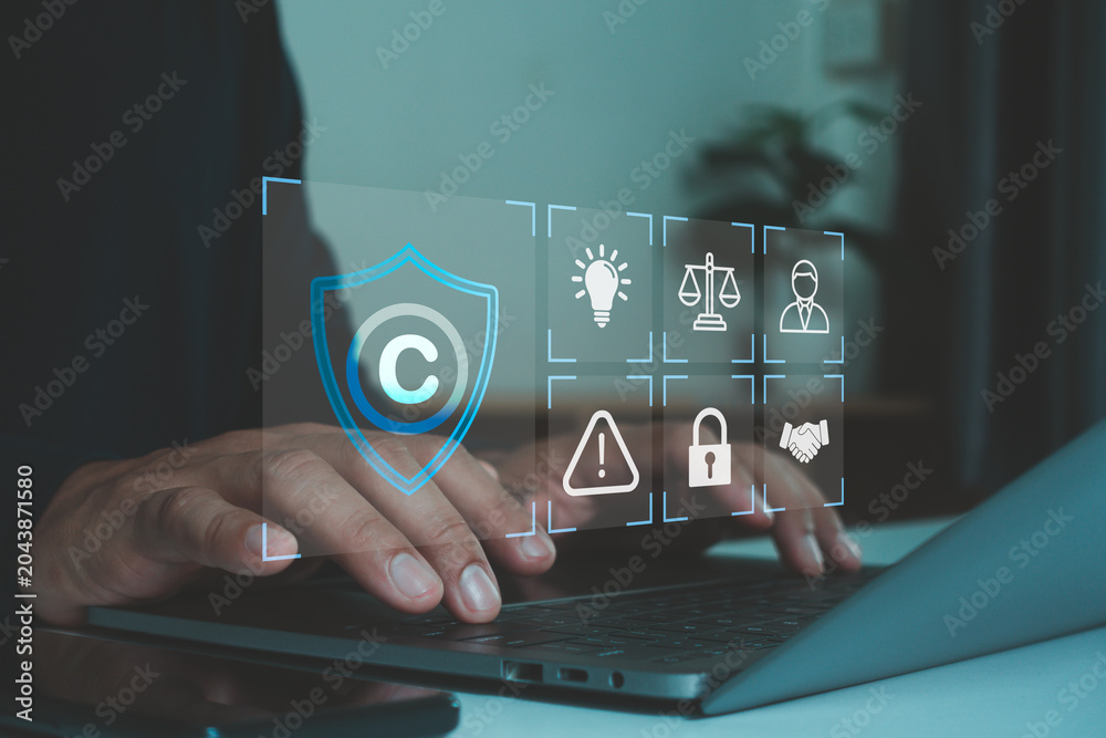 © MUNTHITA - Copyright protection and intellectual property security concept. Digital shield, legal compliance icon, cybersecurity, copyright law, data protection, online security, license, risk management. © MUNTHITA - Copyright protection and intellectual property security concept. Digital shield, legal compliance icon, cybersecurity, copyright law, data protection, online security, license, risk management.