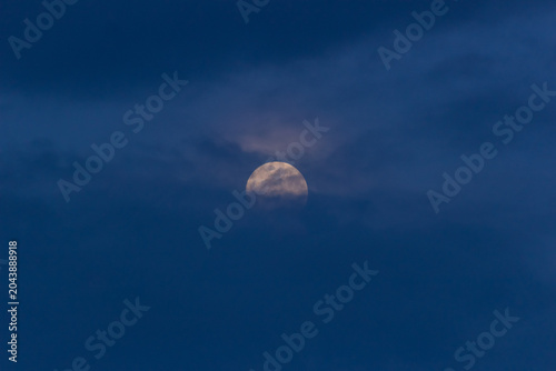 The full moon in the night sky. The moon in the night sky.