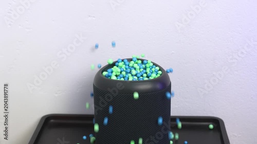 Small colorful beads bouncing off a wireless smart speaker membrane due to powerful sound vibration