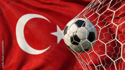 Soccer ball hitting the back of the net for a goal with the national flag of Turkey waving in the background, symbolizing sports success and national pride