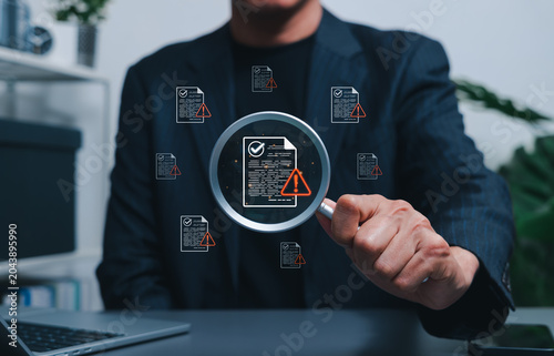 Document risk review and compliance audit warning concept. Businessman using magnifying glass to inspect files with alert icons. document validation, policy control, error detection, quality assurance