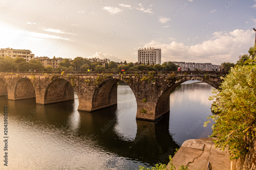 Obraz premium Old stone bridge over Hengjiang river in Tunxi city, Anhui province, China
