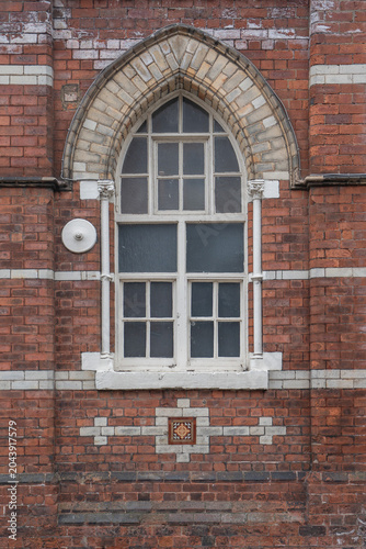 Ancient medieval stone window in an old European castle wall