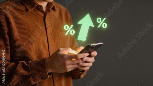 Person using smartphone with financial growth symbols