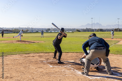 Canvastavla Pitcher delivering pitch, batter swinging bat over plate, aiming to drive in run