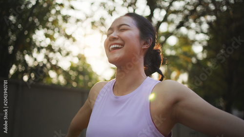 Asia young Gen Z people mindful happy woman open arm relax body deep stress relief outdoor nature green public park sun light self love anti aging life asian female mental health care modern medical.