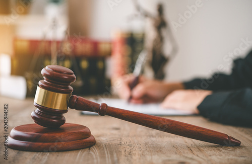 Law theme, mallet of the judge, law enforcement officers, evidence-based cases, and documents taken into account
