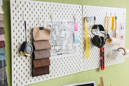 Pegboard with tools and blu...