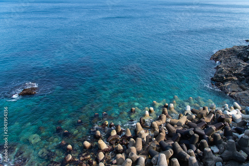 Massive tetrapod breakwater along a beautiful turquoise coast