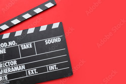 Movie clapper on red backgr...