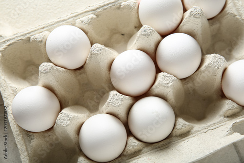 Holder with raw chicken egg...